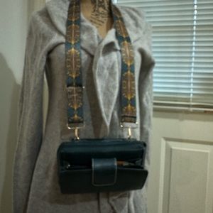 Green travel crossbody wallet with a shopping bag parachute opening if needed